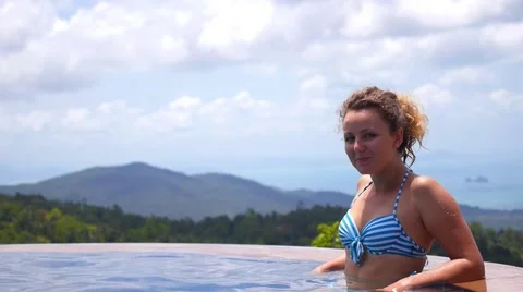 Beautiful Woman Relaxing in Infinity Pool on Vacation Video stock 52540341
