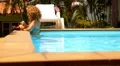 Beautiful Woman Relaxing in Pool and Enjoying Fresh Juice and Fruits. HD Footage