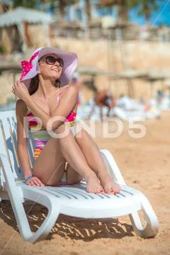 The beautiful woman rest on the beach Stock Photos