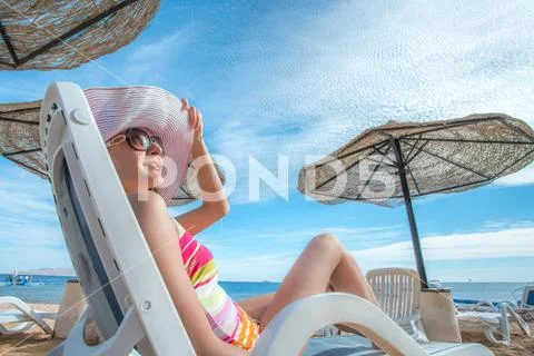 The beautiful woman rest on the sea beach Stock Photos