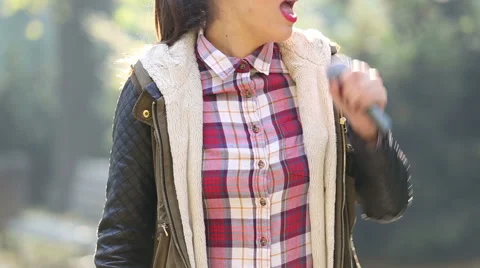 Beautiful woman singing with the microphone Stock Footage 59556556