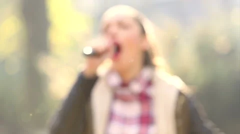 Beautiful woman singing with the microphone Stock Footage 59556577