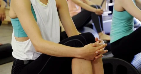 Beautiful woman sitting in fitness studio Stock Footage