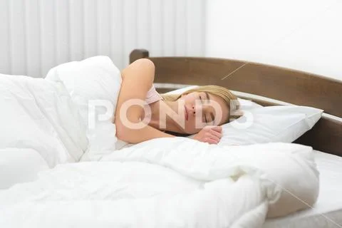 The beautiful woman sleeping on the bed Stock Photos