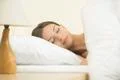 The beautiful woman sleeping on the bed with white linens Photo