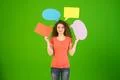 The beautiful woman stand and hold dialog signs on the green background Photo