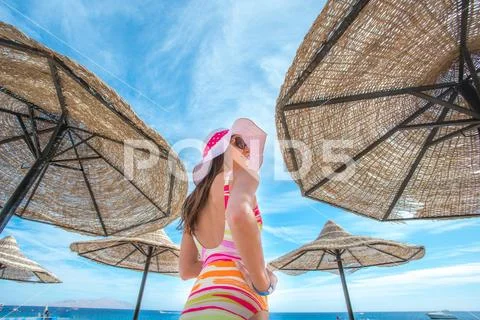 The beautiful woman stand in the beach on the sea background Stock Photos