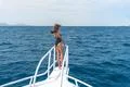 The beautiful woman stand in the yacht on the sea background Photo