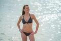 The beautiful woman in swimsuit stand in the sea Photo