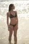 The beautiful woman in swimsuit stand in the sea Photo