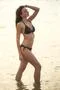 The beautiful woman in swimsuit stand in the sea Photo