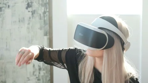 Beautiful woman touch something using modern virtual reality glasses Stock Footage 73853905