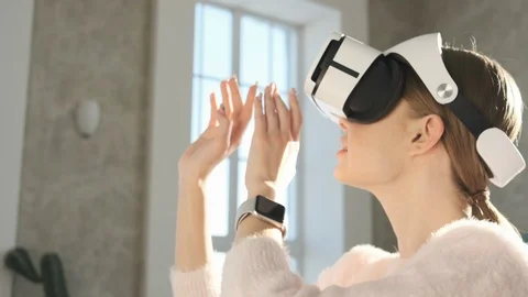 Beautiful woman touch something using modern virtual reality glasses. Stock Footage 102739153