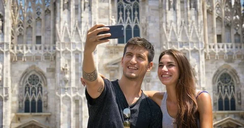 A beautiful woman in town is listening to music, taking pictures, Stock Footage