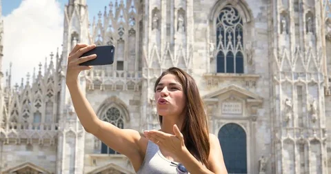 A beautiful woman in town is listening to music, taking pictures, Stock Footage