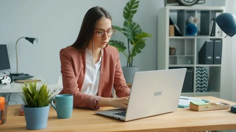 Beautiful woman using computer then taking off glasses touching eyes in office 動画素材 120190466