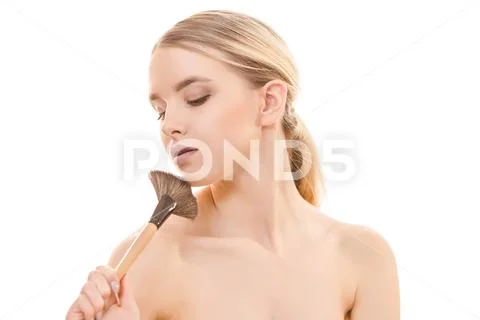 The beautiful woman using a cosmetic brush on the white background Stock Photos