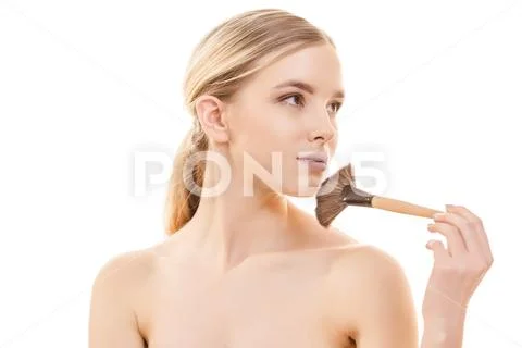The beautiful woman using a cosmetic brush on the white background Stock Photos