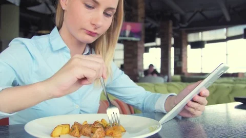 Beautiful woman using ipad tablet computer touchscreen in cafe Stock Footage 74397489