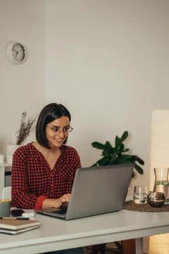 Beautiful woman using a laptop while working from home Stock Photos