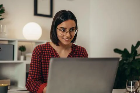 Beautiful woman using a laptop while working from home Stock Photos