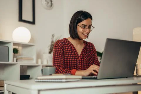 Beautiful woman using a laptop while working from home Stock Photos