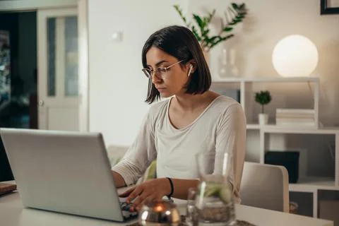 Beautiful woman using a laptop while working from home Stock Photos