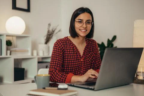Beautiful woman using a laptop while working from home Stock-Fotos