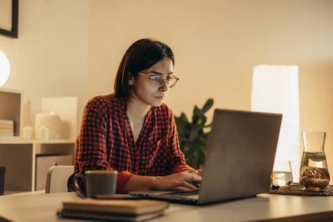 Beautiful woman using laptop while working from home Stock Photos