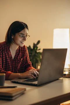 Beautiful woman using laptop while working from home Stock Photos