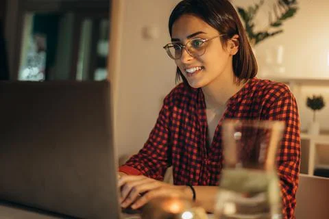 Beautiful woman using laptop while working from home Stock Photos