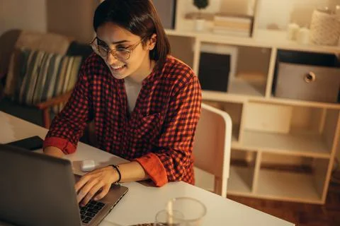 Beautiful woman using laptop while working from home Stock Photos