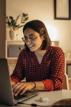 Beautiful woman using laptop while working from home Stock Photos