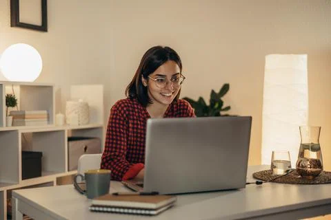 Beautiful woman using laptop while working from home Stock Photos