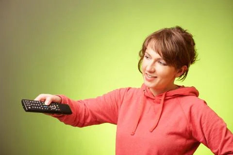 Beautiful woman using a remote controller Stock Photos