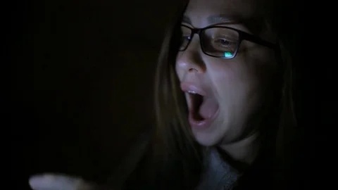 Beautiful woman using smartphone at home late night, very surprised, emotions Stock Footage 81336341