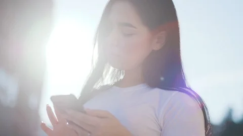 Beautiful woman using smartphone while walking on city avenue - focus on Video stock 111220076