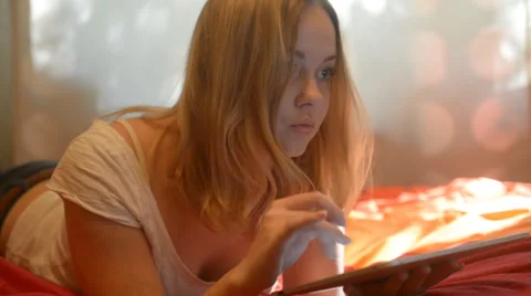 Beautiful woman using tablet lying on her bed Video stock 42006185