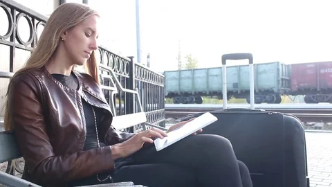 Beautiful woman using tablet on the platform Stock Footage 77076734