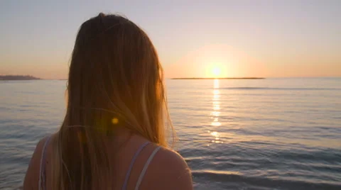 Beautiful woman walking on the beach at sunset Stock Footage 59337652
