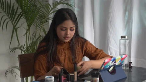 Beautiful woman watching make up tutorial video learning how to do make up. Video stock 150881284