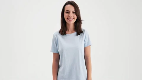 A beautiful woman wearing basic t-shirt is looking to the camera Stock Footage 157866955