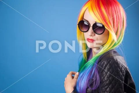 Beautiful woman wearing color wig and sunglasses Stock Photos