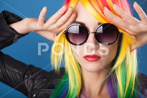 Beautiful woman wearing color wig and sunglasses Stock Photos