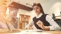 The beautiful woman working at the desktop with a modern laptop 4k or 4k+ Resolution