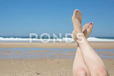 Beautiful Woman's Legs On The Beach