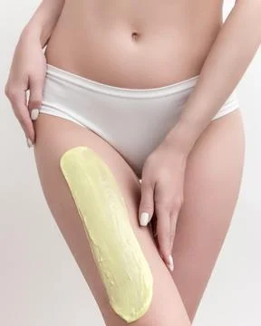 Beautiful woman's body in white panties during depilation process with hot wax Stock Photos