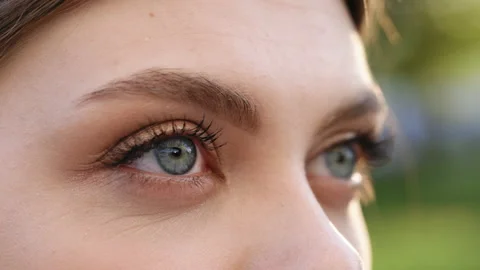 Beautiful woman's eyes opening while looking at Camera, having long nice Stock Footage 197035605