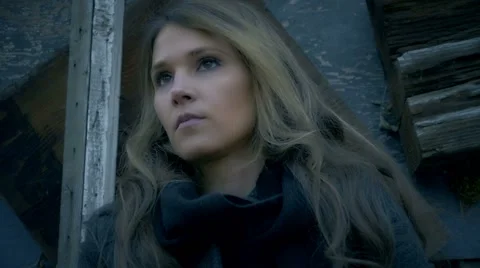 Beautiful woman's face low angle tracked shot old building in bckground Video stock 60277461