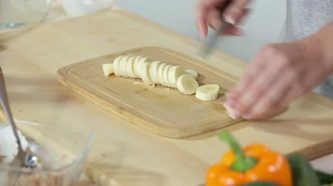 Beautiful woman's hands cut slice  banana kiwi strawberry Stock Footage 67455442